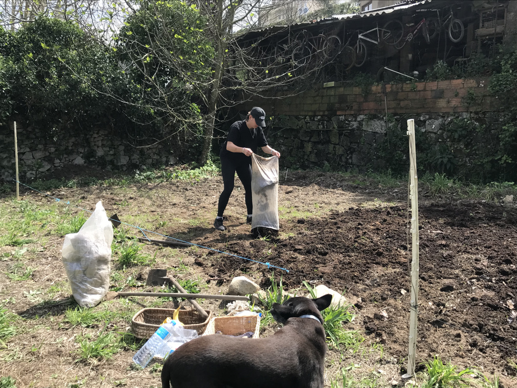 Adding compost to a field Monchique Homestead